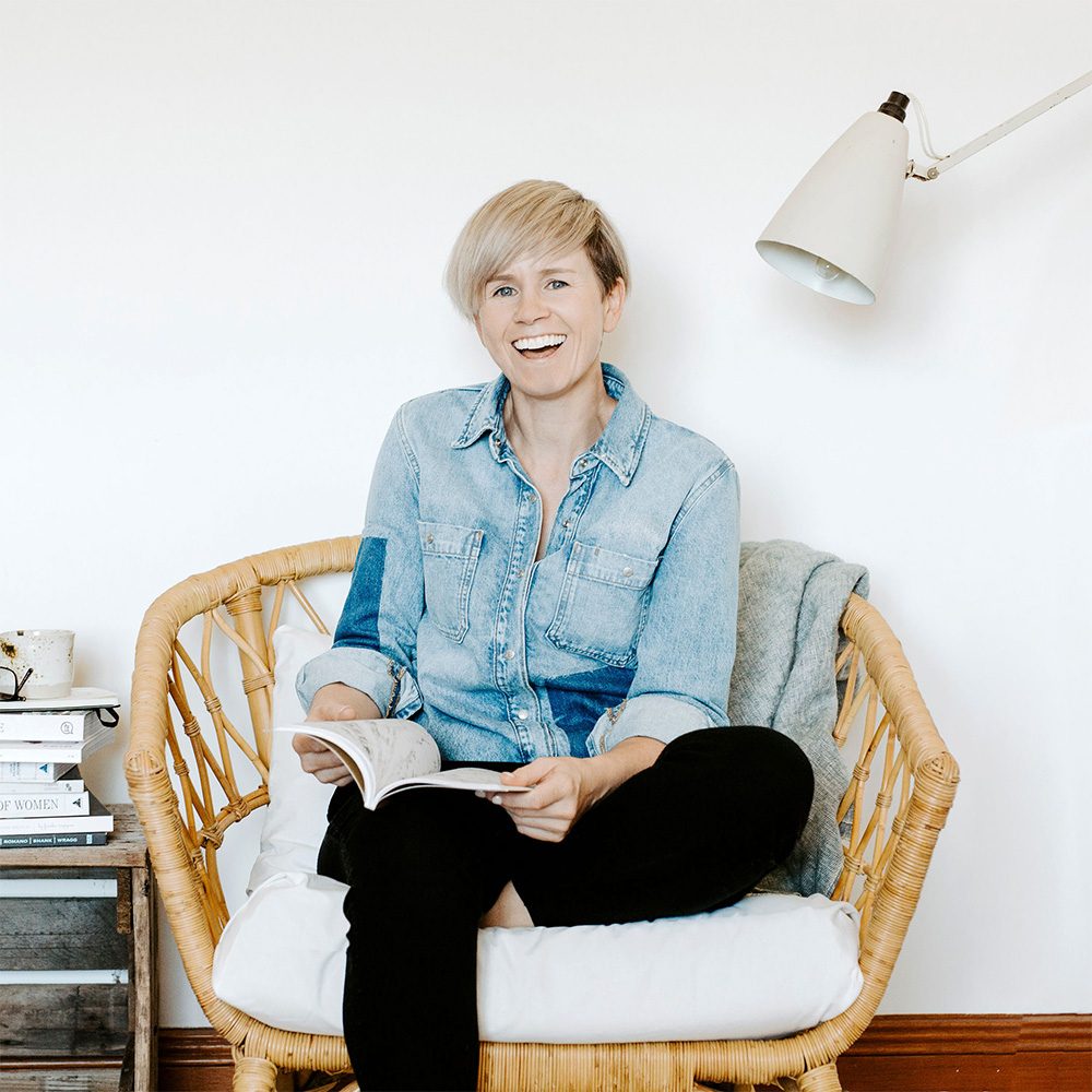 A picture of me sitting on a chair reading surrounded by some books that I love