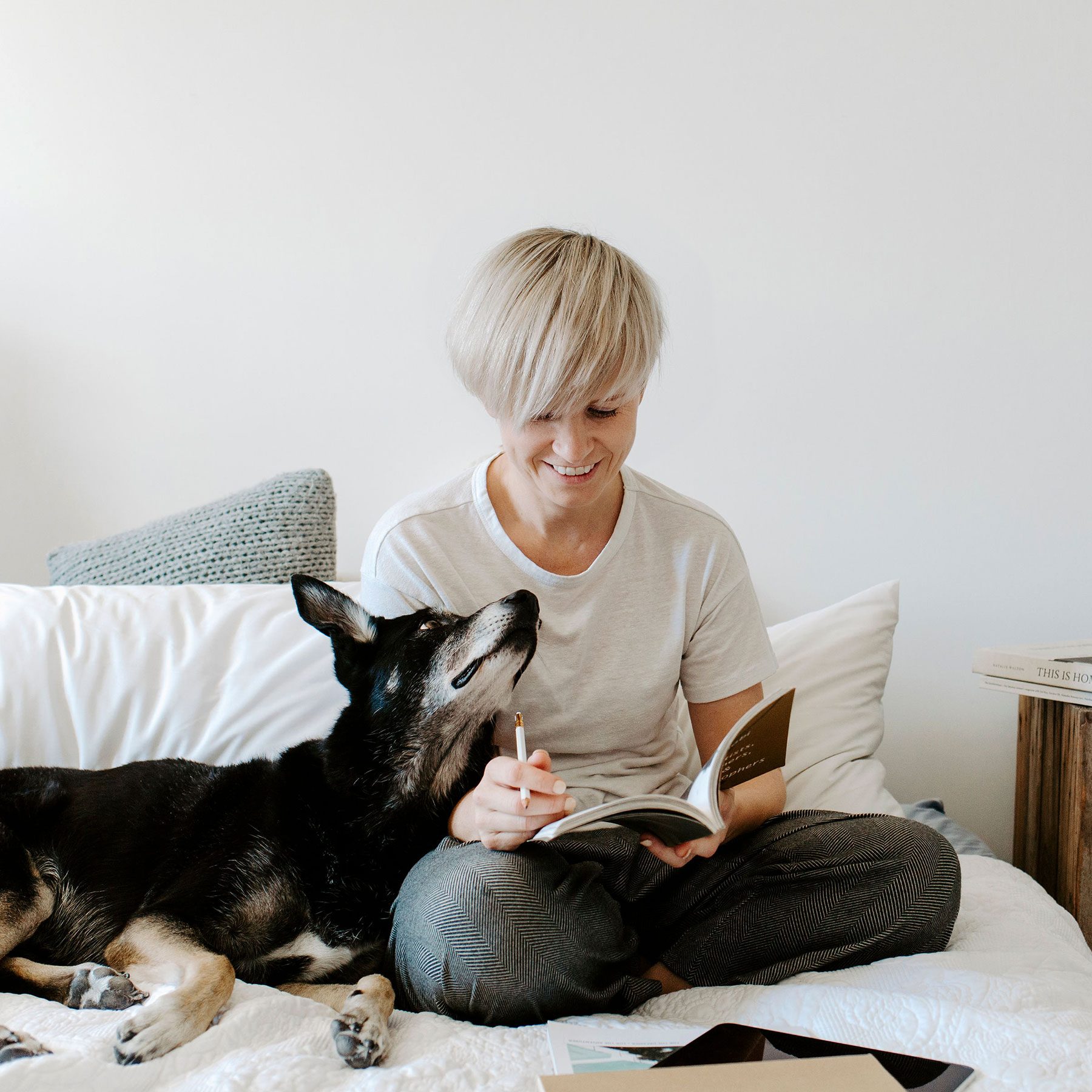 Sitting on the bed with Elroy my kelpie reading